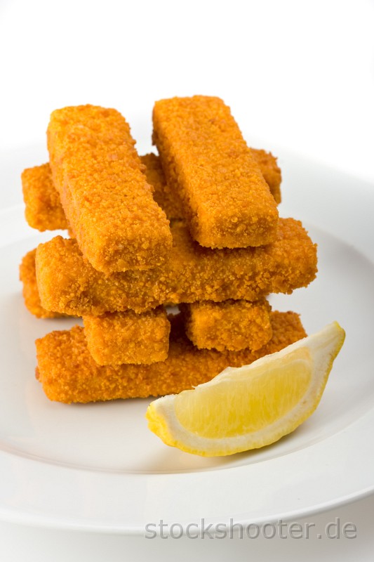 IMG_0824_fishfingers_ala.jpg - eight fish fingers on a white plate