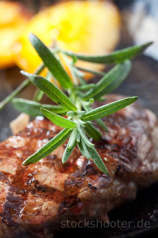 _MG_2077_steakpan.jpg - closeup of a rosemary leaf on a steak